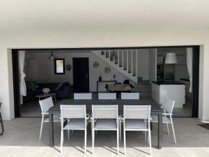 a dining room and kitchen with a table and chairs at Villa Mamago in Cirendinu