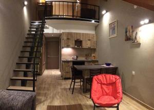 a room with a staircase and a table and a kitchen at Two various entire apartments in New Gudauri -Redco, Near Main Gondola in Gudauri
