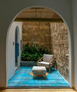 a chair and a ottoman sitting on a patio at MOONLIGHT Homestay & Hotel in Pleiku