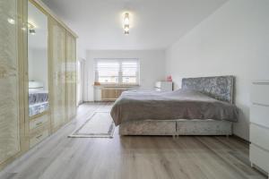 a bedroom with a bed and a dresser at Private House in Hannover