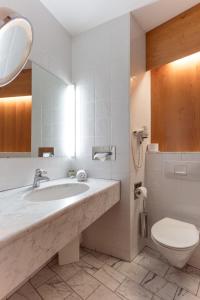 a bathroom with a sink and a toilet at Hotel Restaurant Südrast Dreiländereck in Arnoldstein