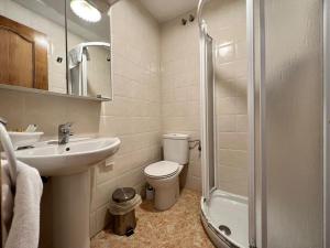a bathroom with a toilet and a sink and a shower at Cozy apartment, FreeWifi, nearby beach in Cadavedo in Cadavedo
