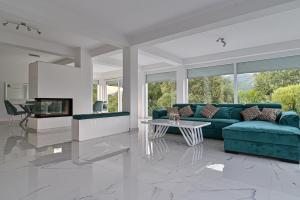 a living room with a blue couch and a table at Summer Residence Una in Bihać