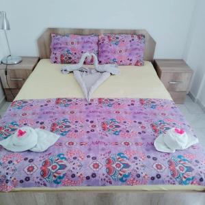 a bed with two pairs of shoes on it at Belka Golf Residence Exclusive Apt Poolside in Belek