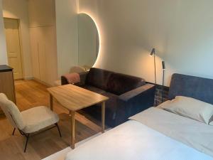 a living room with a couch and a table and a bed at Vallikraavi Studio Apartment in Tartu