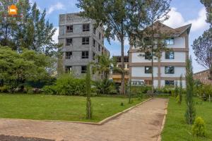 an apartment building with a park in front of it at Arabel Studio with Swimming Pool in Nanyuki