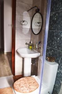 a bathroom with a sink and a shower and a toilet at Cheerful 4-bedroom with pool in Athi River