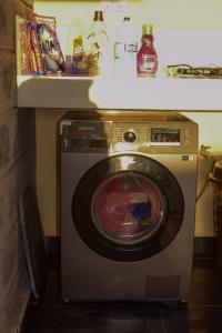 a washing machine in a room with a shelf at Cheerful 4-bedroom with pool in Athi River