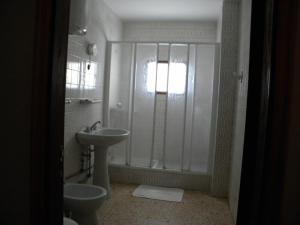 a bathroom with a shower and a sink and a toilet at Apartamentos Restinga in La Restinga