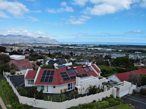 a house with solar panels on the roof at Somerset View Guest House in Somerset West