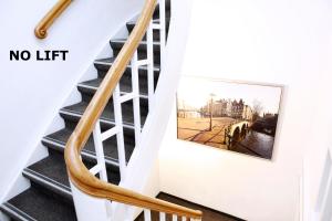 a staircase with a no lift picture on the wall at Hotel Damsquare in Amsterdam