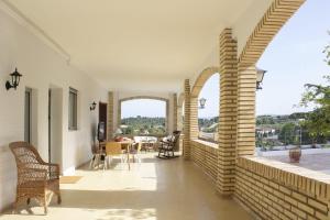 a hallway of a house with a table and chairs at El Recreo, private Pool & Bbq in Godelleta