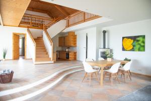 a kitchen and dining room with a wooden table and chairs at Seehof direkt am See mit privatem Seezugang 