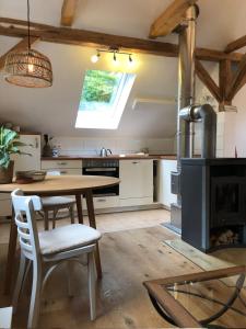 a kitchen with a wooden table and a stove at s'Scheunle - dein Ferienhäusle im Donautal in Beuron