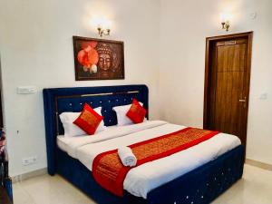 a bedroom with a large bed with red and white pillows at Fortune Home Service Apartment 2Bhk,E28 Saket 2A in New Delhi