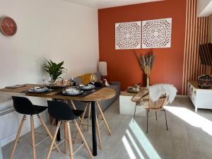 a dining room with a table and chairs at - NEW - La TerraCalm - WiFi / Netflix in Cherbourg en Cotentin