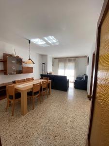 ein Wohnzimmer mit einem Tisch und einem Sofa in der Unterkunft Apartaments Sant Antoni in Ribes de Freser