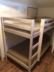 a pair of bunk beds in a room at Chalet cosy Duplex 6 personnes in Saint-Sorlin-dʼArves