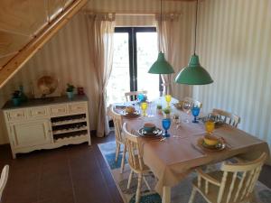 a dining room with a table with chairs and a window at Villa Ana in Nazaré