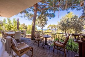 a deck with furniture and a table and chairs at Charming Home Surrounded by Nature in Kas in Gelemiş