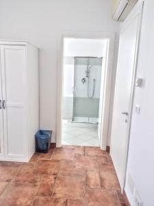 a bathroom with a shower and a tile floor at Affittacamere di Andrea Bertolino Argelato in Argelato