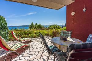 a patio with a table and chairs on a balcony at Apartments Milica in Crikvenica