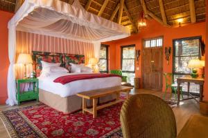 a bedroom with a large bed with a canopy at Royal Malewane in Thornybush Game Reserve