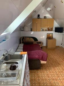 a bathroom with a sink and a bed in a room at Poilsis pas Lidyja 