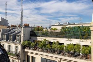 a building with plants on the roof of it at Hotel Elysees 8 in Paris