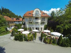 a large white building with umbrellas in front of it at Parkhotel Bad Faulenbach in Füssen