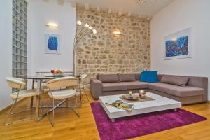 a living room with a couch and a table at Dubrovnik Dream Apartments in Dubrovnik