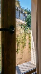 an open door with a view of a dirt road at Hotel Boutique Puerta de las Granadas in Granada