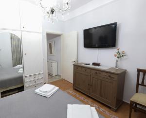 a living room with a flat screen tv on the wall at Angels' House in Thessaloniki