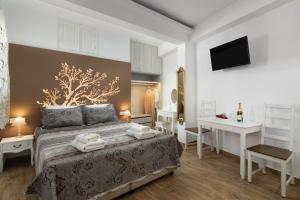 a bedroom with a bed with towels on it at Chrysanthi Studios in Líndos