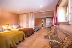 a hotel room with two beds and a window at La Ferme des Fingères in Cordon