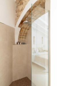 a glass shower in a bedroom with a bed at Casa Rural Lliber in Lliber