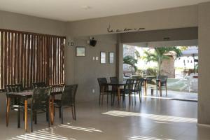 a dining room with wooden tables and chairs at Locanda dei Venti in Itarema
