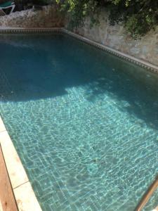 a large swimming pool with blue water at Apartamento El Mirador Rocabella in El Chorro