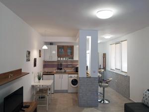 a living room with a kitchen and a living room with at Comfortable Ground Floor Studio in Primorsko