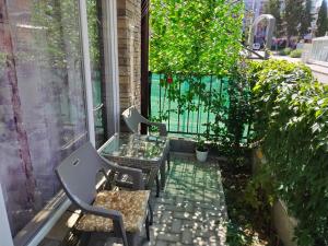 a balcony with two chairs and a glass table at Comfortable Ground Floor Studio in Primorsko