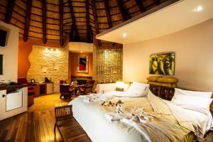a bedroom with a large white bed in a room at Maliba Mountain Lodge in Butha-Buthe