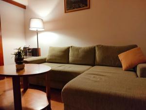 a living room with a couch and a table at Eternity Chalet Trnovec in Liptovský Trnovec