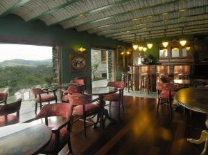 a restaurant with tables and chairs and a view at Casona El Gurugu in Luarca