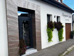 a store front with a black door and ivy at Margaréta Garden & SPA in Eger
