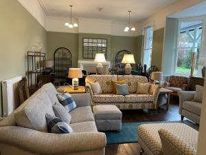 a living room with two couches and a couch at The Elan Valley Hotel in Rhayader