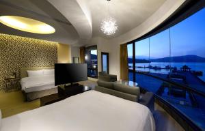 a hotel room with a bed and a large window at Hu Yue Lakeview Hotel in Yuchi