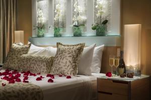 a bedroom with a bed with red roses on it at Santa Maria Suites Resort in Key West