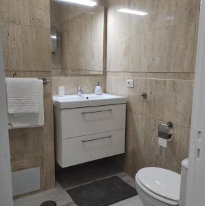 ein Badezimmer mit einem weißen Waschbecken und einem WC in der Unterkunft Cozy Studio Harbour View in Puerto de la Cruz in Puerto de la Cruz