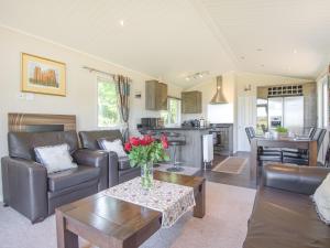 - un salon avec un canapé et une table dans l'établissement The Lodge At Newmeads Farm, à West Pennard