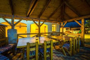 a large wooden table and chairs on a patio at Apartmany Centrum in Pavčina Lehota